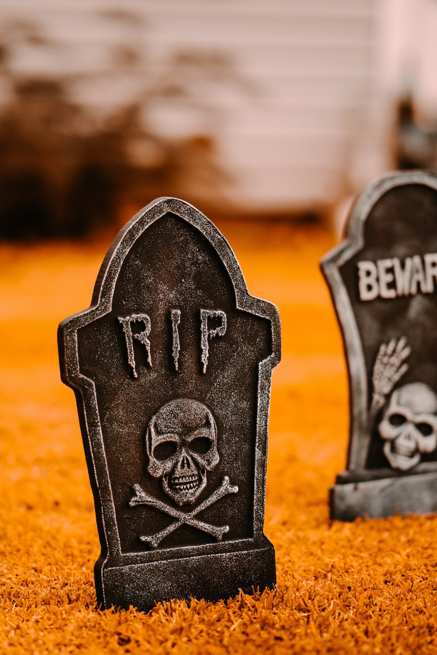 halloween headstones on grassy ground