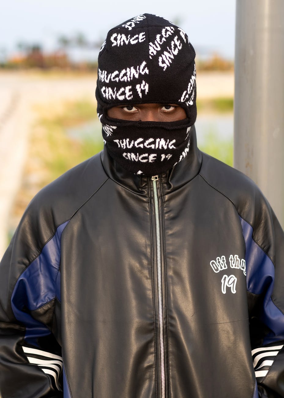 man in balaclava and black leather jacket